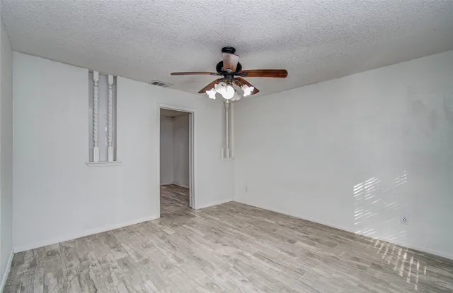 a very nice looking room with a chandelier fan