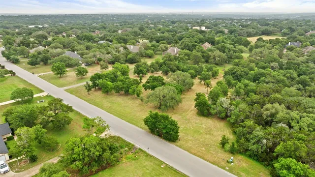 an aerial view of a forest with houses