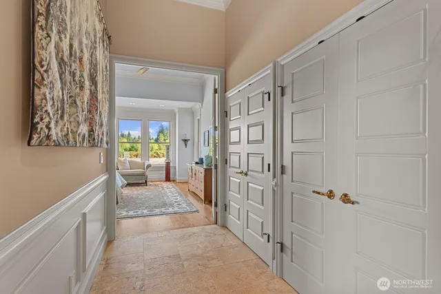 a view of a hallway with a livingroom and furniture