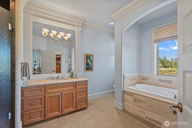 a bathroom with a tub sink and mirror