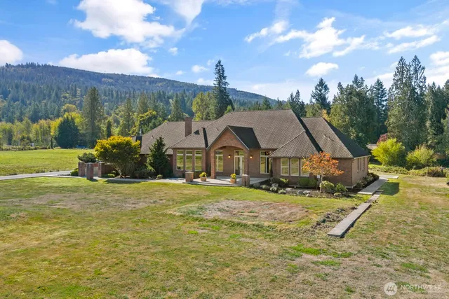 a house with green field in front of it