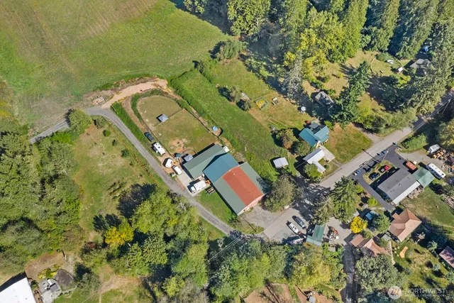 an aerial view of a house with a yard and swimming pool