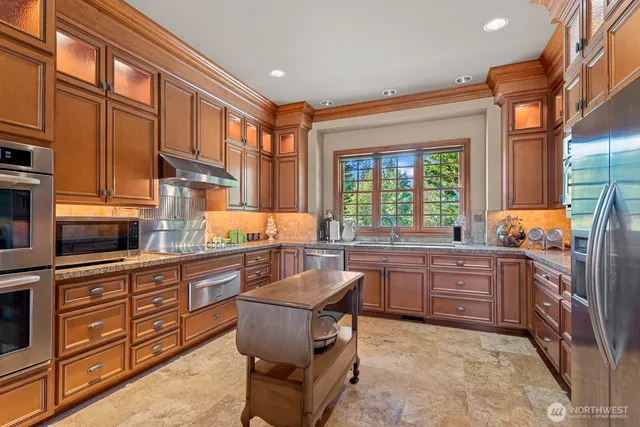 a kitchen with stainless steel appliances granite countertop a sink and cabinets