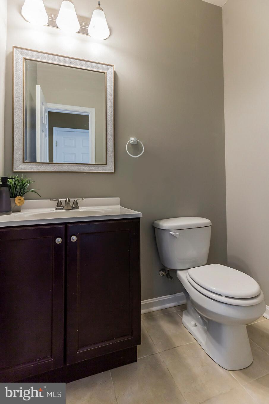3195 Hickory Ridge Road Dunkirk, MD 20754 - Photo 13 of 41 a bathroom with a granite countertop toilet sink and mirror
