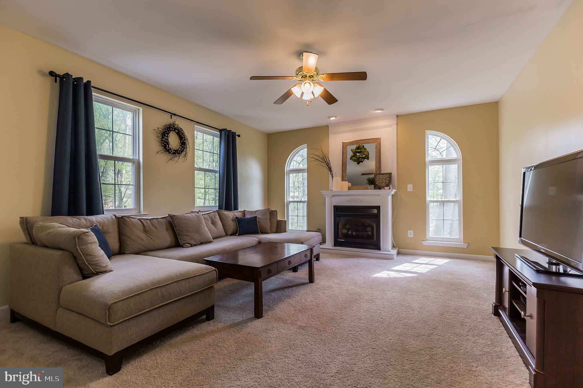 3195 Hickory Ridge Road Dunkirk, MD 20754 - Photo 3 of 41 a living room with furniture a fireplace and a flat screen tv