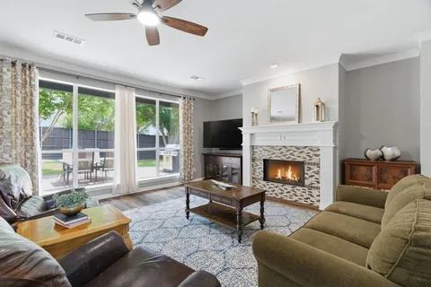 a living room with furniture and a fireplace