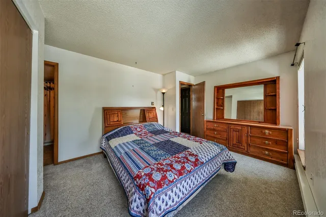 a bedroom with a bed and a dresser