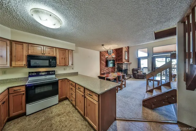 a kitchen with sink stove and cabinets