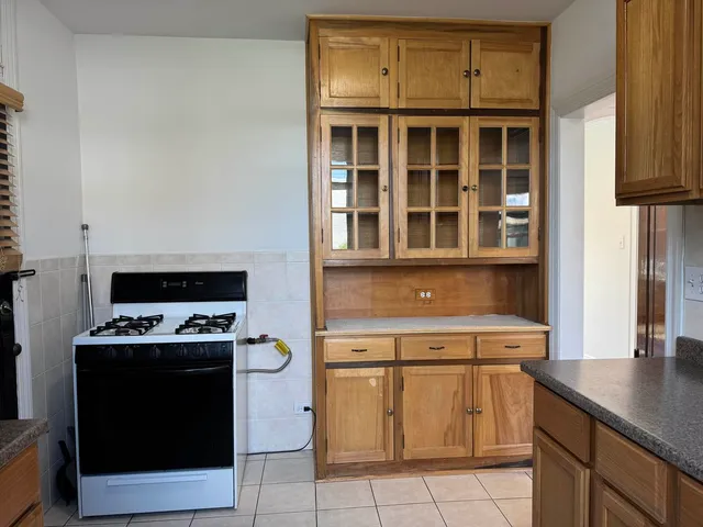 a kitchen with stainless steel appliances granite countertop a stove and a cabinets