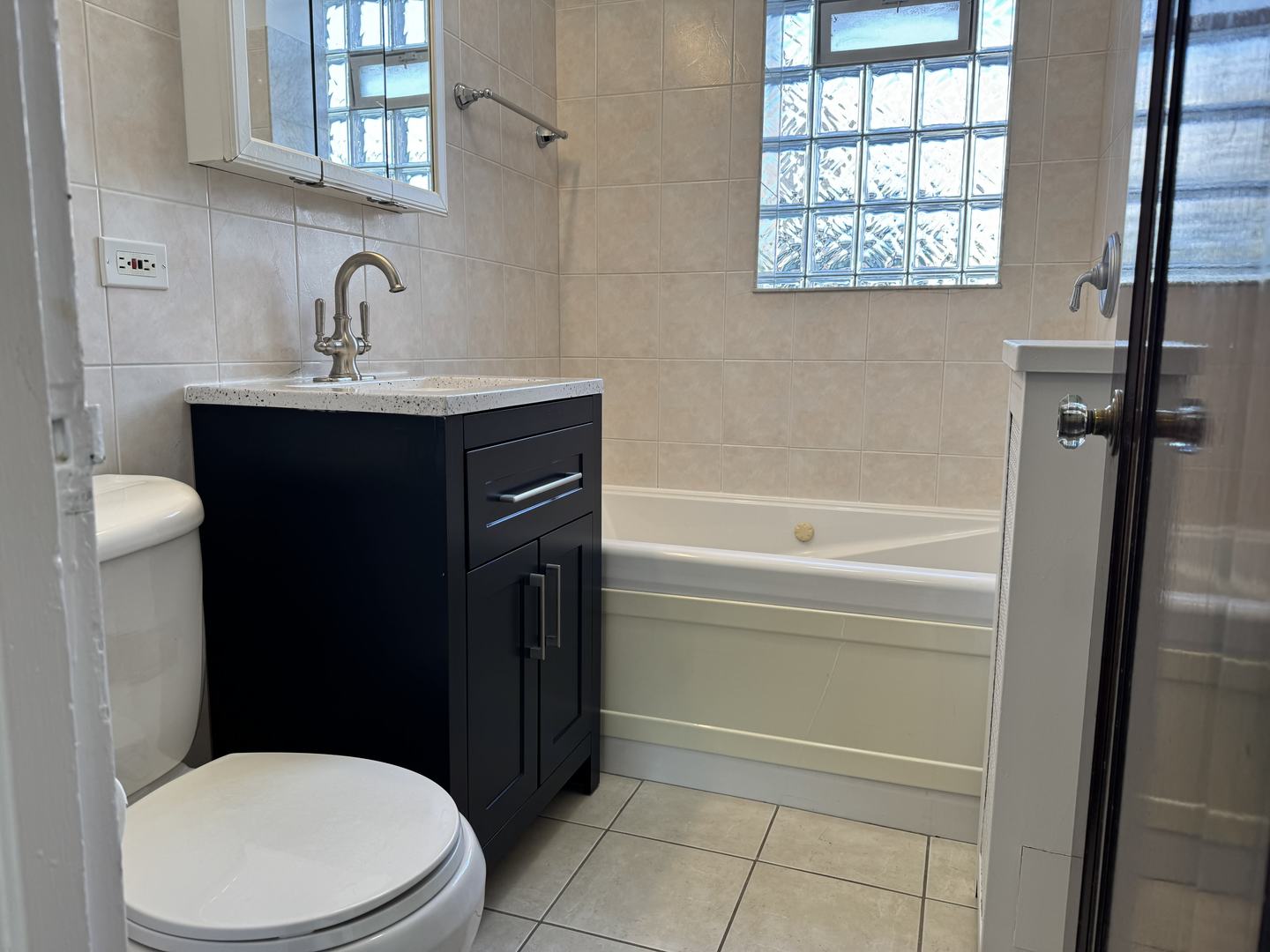 2524 West Ardmore Avenue, Unit 1 Chicago, IL 60659 - Photo 16 of 21 a bathroom with a sink a toilet and a bathtub