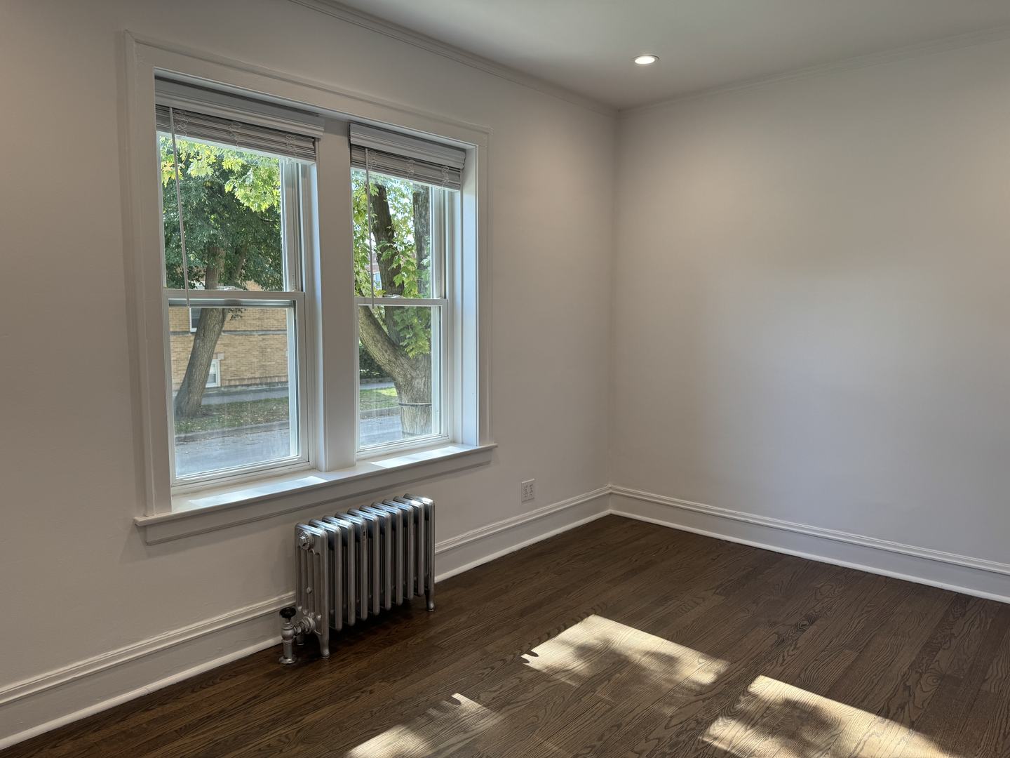 2524 West Ardmore Avenue, Unit 1 Chicago, IL 60659 - Photo 19 of 21 a view of an empty room with wooden floor and a window