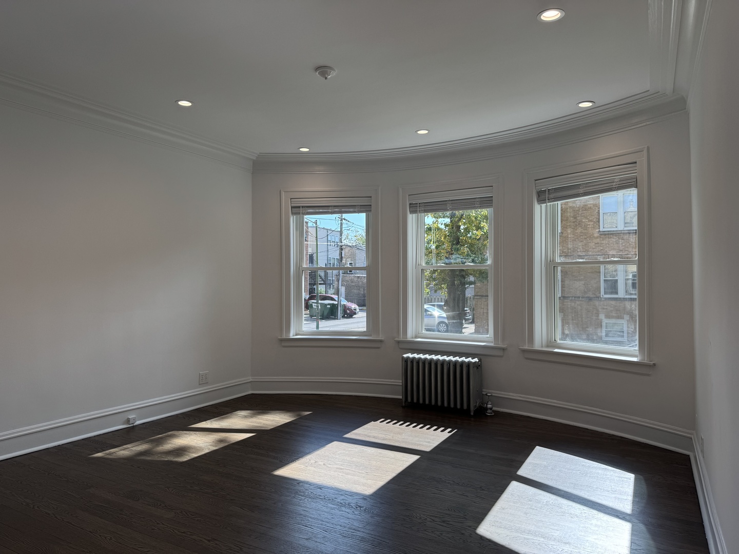2524 West Ardmore Avenue, Unit 1 Chicago, IL 60659 - Photo 5 of 21 a room with wooden floor and windows