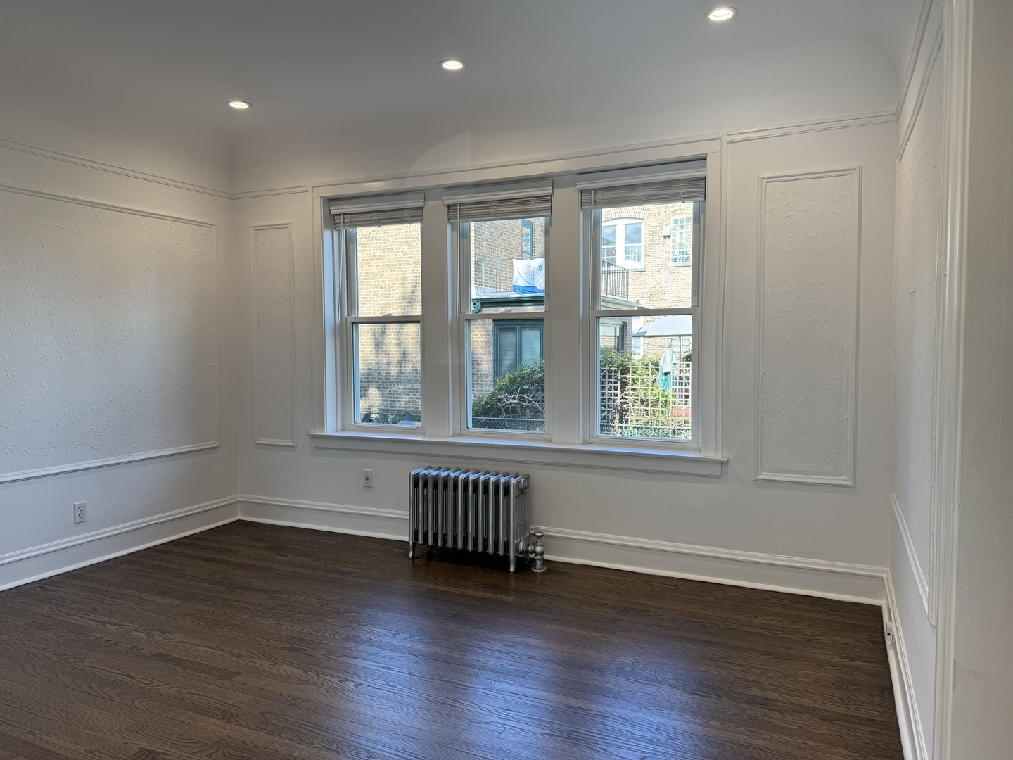2524 West Ardmore Avenue, Unit 1 Chicago, IL 60659 - Photo 6 of 21 an empty room with wooden floor and windows