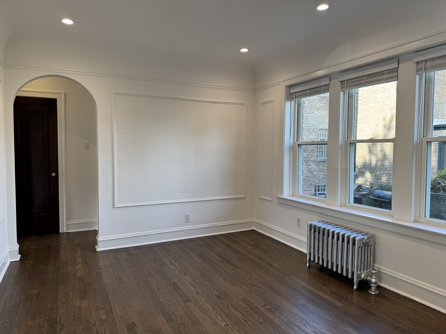 2524 West Ardmore Avenue, Unit 1 Chicago, IL 60659 - Photo 9 of 21 an empty room with wooden floor and windows