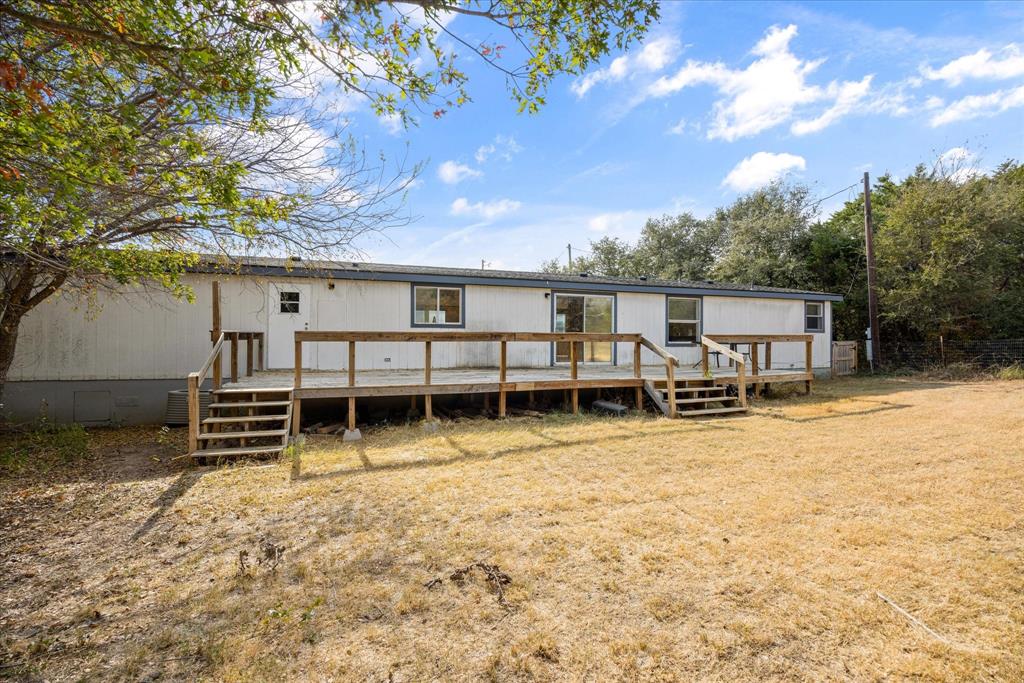 2903 Centaurus Way Granbury, TX 76048 - Photo 30 of 31 Back of house with a deck and a lawn