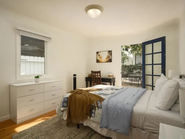 a bedroom with a bed and a window