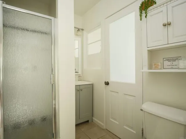 a bathroom with a shower and a toilet