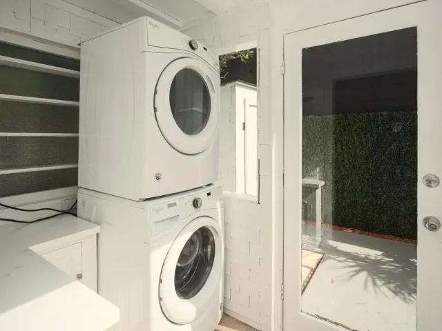 a view of a hallway with washer and dryer