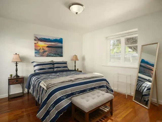 a bedroom with bed and a flat screen tv