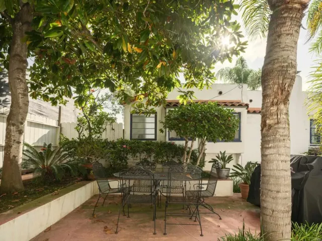 a view of a patio with table and chairs and potted plants