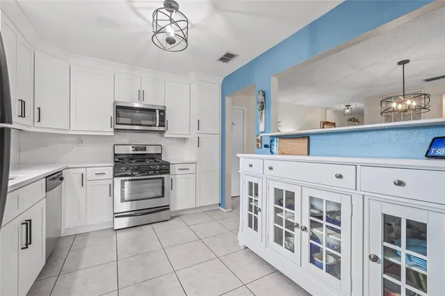 a kitchen with stainless steel appliances a stove a sink and a refrigerator