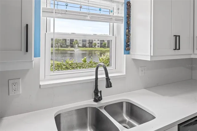 a kitchen with a sink and cabinet