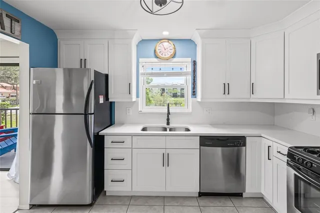 a kitchen with appliances a sink and a window