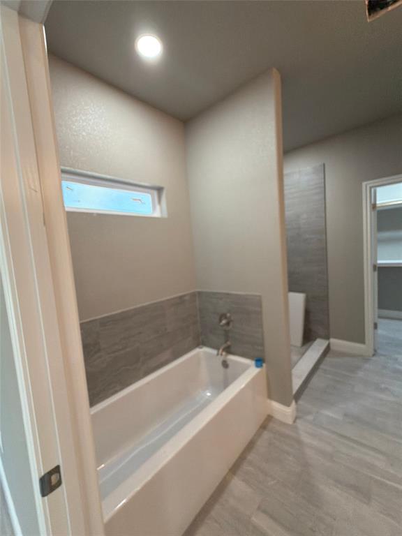 411 Hamilton Road Mineral Wells, TX 76067 - Photo 9 of 12 a white bath tub sitting in a bathroom