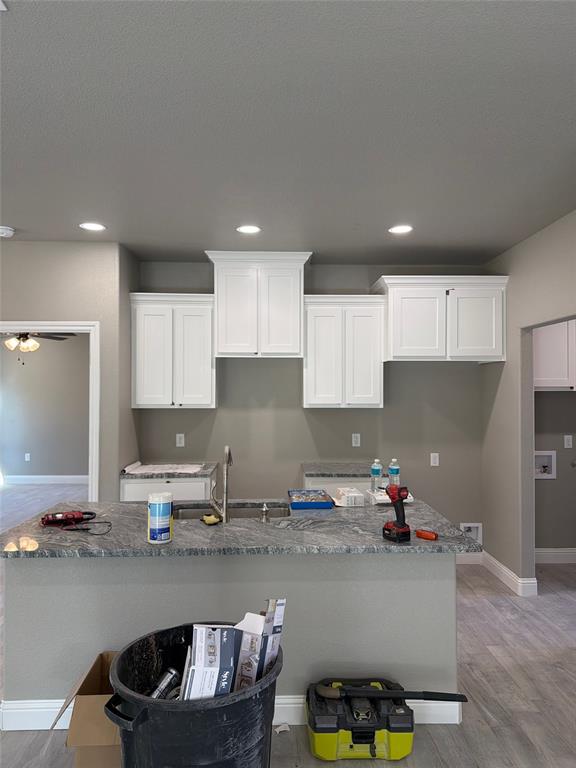 411 Hamilton Road Mineral Wells, TX 76067 - Photo 5 of 12 a kitchen with granite countertop a sink a stove and cabinets