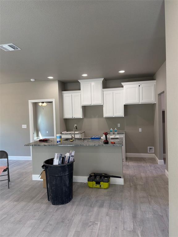 411 Hamilton Road Mineral Wells, TX 76067 - Photo 6 of 12 a kitchen with a refrigerator and a stove top oven