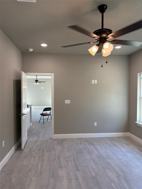 411 Hamilton Road Mineral Wells, TX 76067 - Photo 7 of 12 a view of a room with a ceiling fan and a window