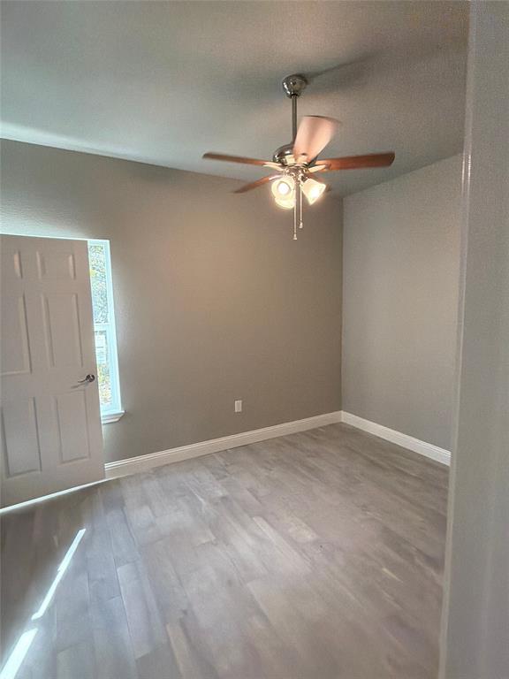 411 Hamilton Road Mineral Wells, TX 76067 - Photo 8 of 12 an empty room with windows and fan