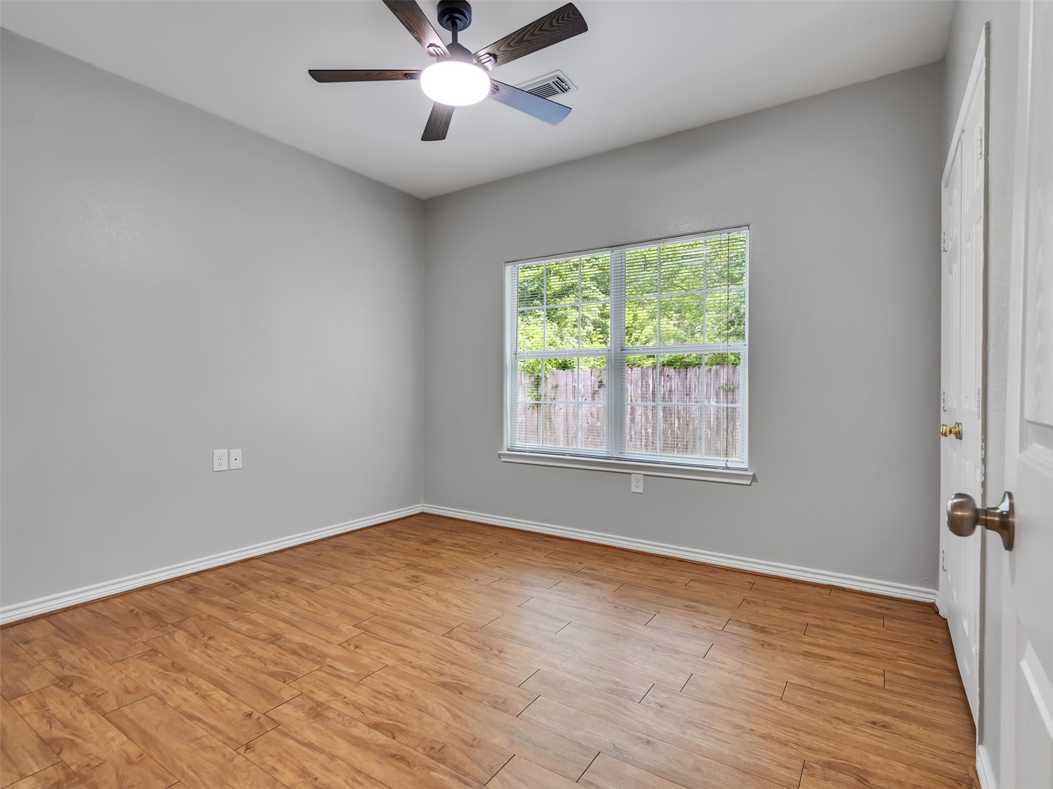 104 Longstreet Road, Unit 2 Willis, TX 77378 - Photo 19 of 26 a view of an empty room with wooden floor and a window