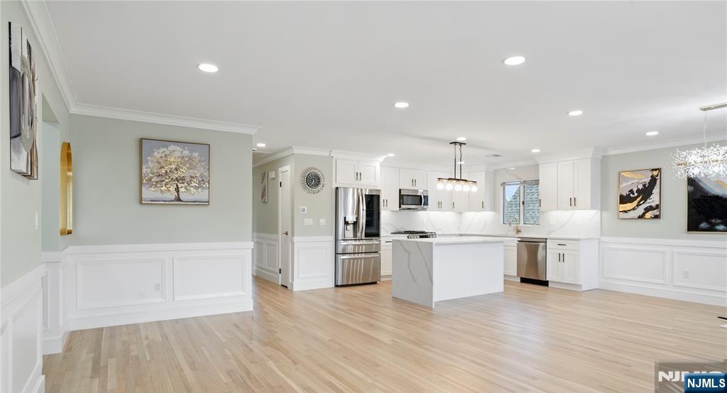 243 Hayward Place Wallington, NJ 07057 - Photo 2 of 9 a large kitchen with a wooden floor and stainless steel appliances
