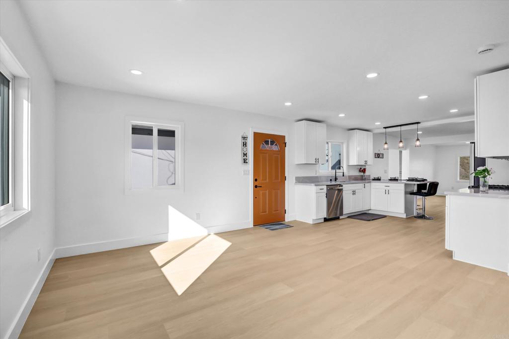323 South 65th Street Encanto, CA 92114 - Photo 15 of 44 a view of kitchen with kitchen island white cabinets and refrigerator