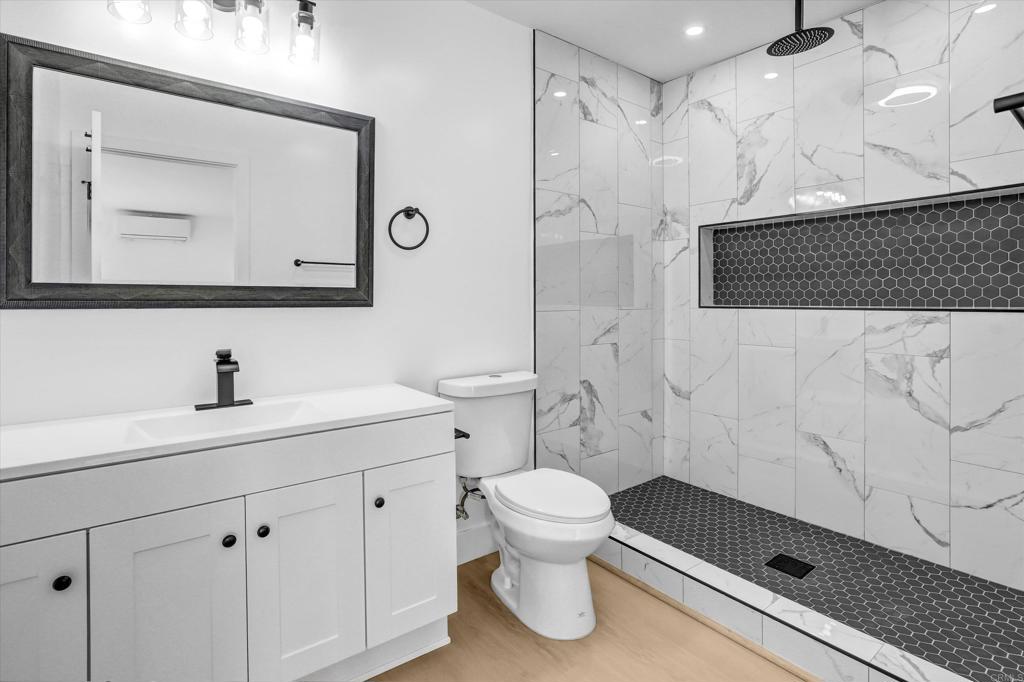 323 South 65th Street Encanto, CA 92114 - Photo 22 of 44 a bathroom with a sink a toilet and a mirror