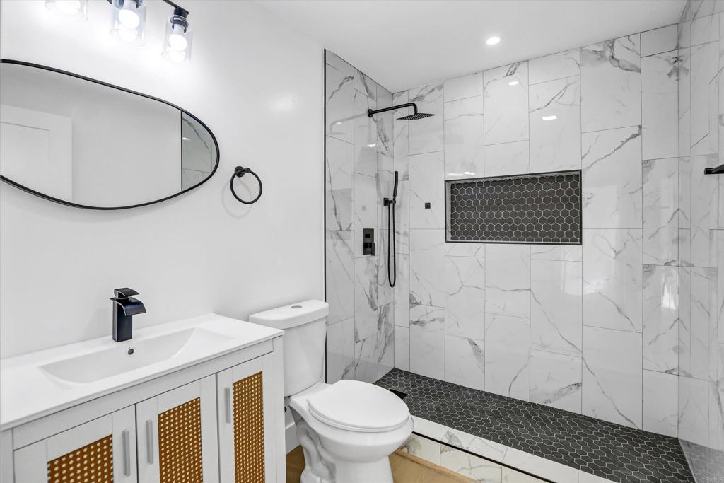 323 South 65th Street Encanto, CA 92114 - Photo 32 of 44 a bathroom with a sink a toilet and shower
