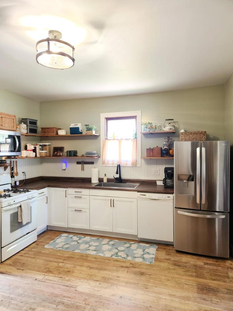 701 South 20th Street Murphysboro, IL 62966 - Photo 28 of 32 a kitchen with stainless steel appliances granite countertop a refrigerator a stove and a sink with cabinets