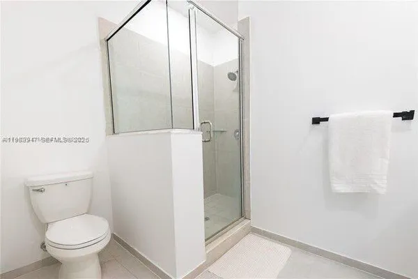 a bathroom with a shower and a toilet