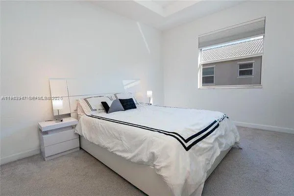 a bedroom with a bed and window