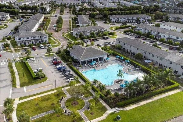 an aerial view of residential houses with outdoor space