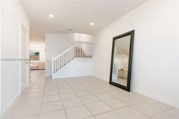 a view of a hallway with a bathroom
