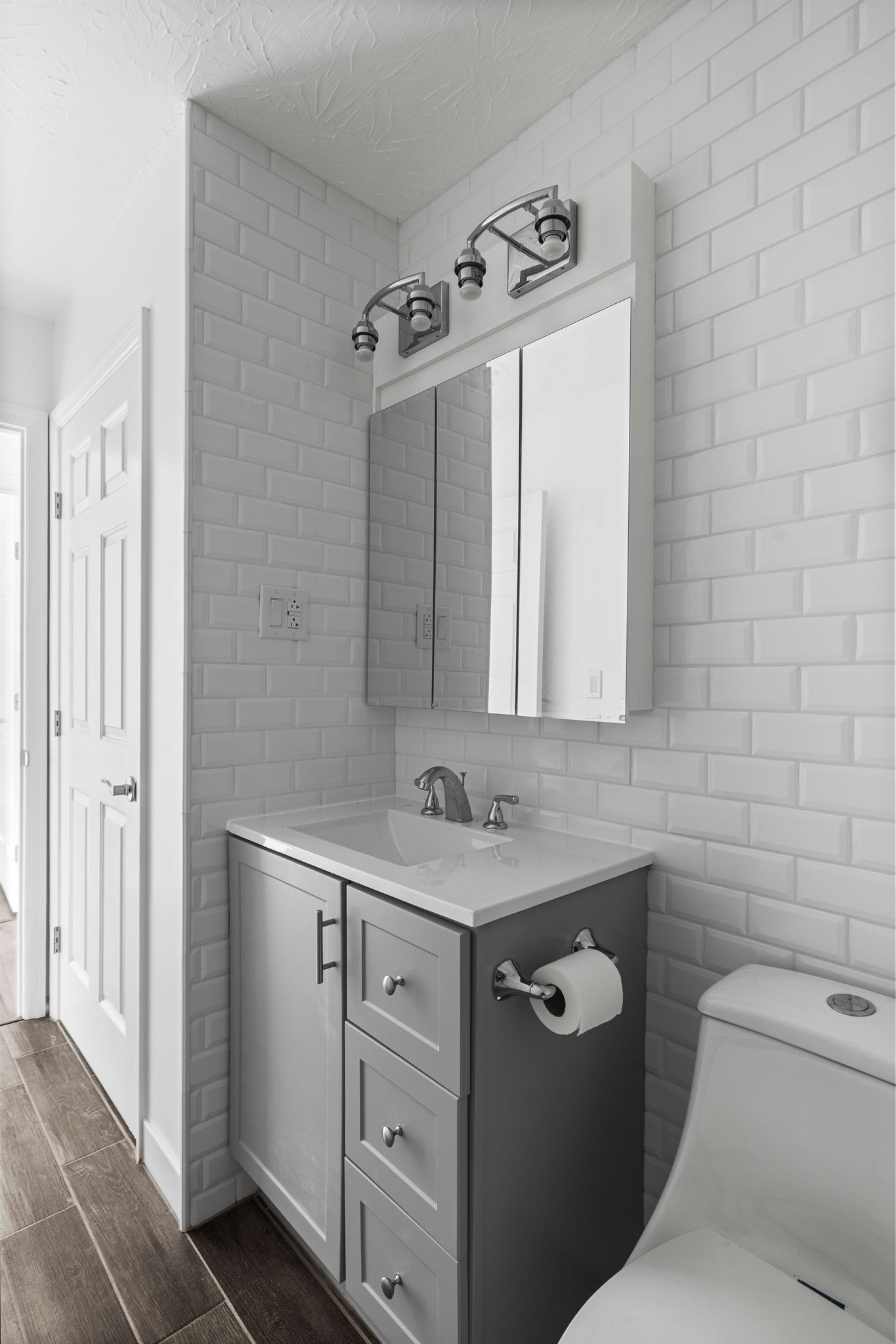 104 East Merchant Street Mount Pleasant, TN 38474 - Photo 13 of 30 a bathroom with a granite countertop sink a toilet a mirror and shower