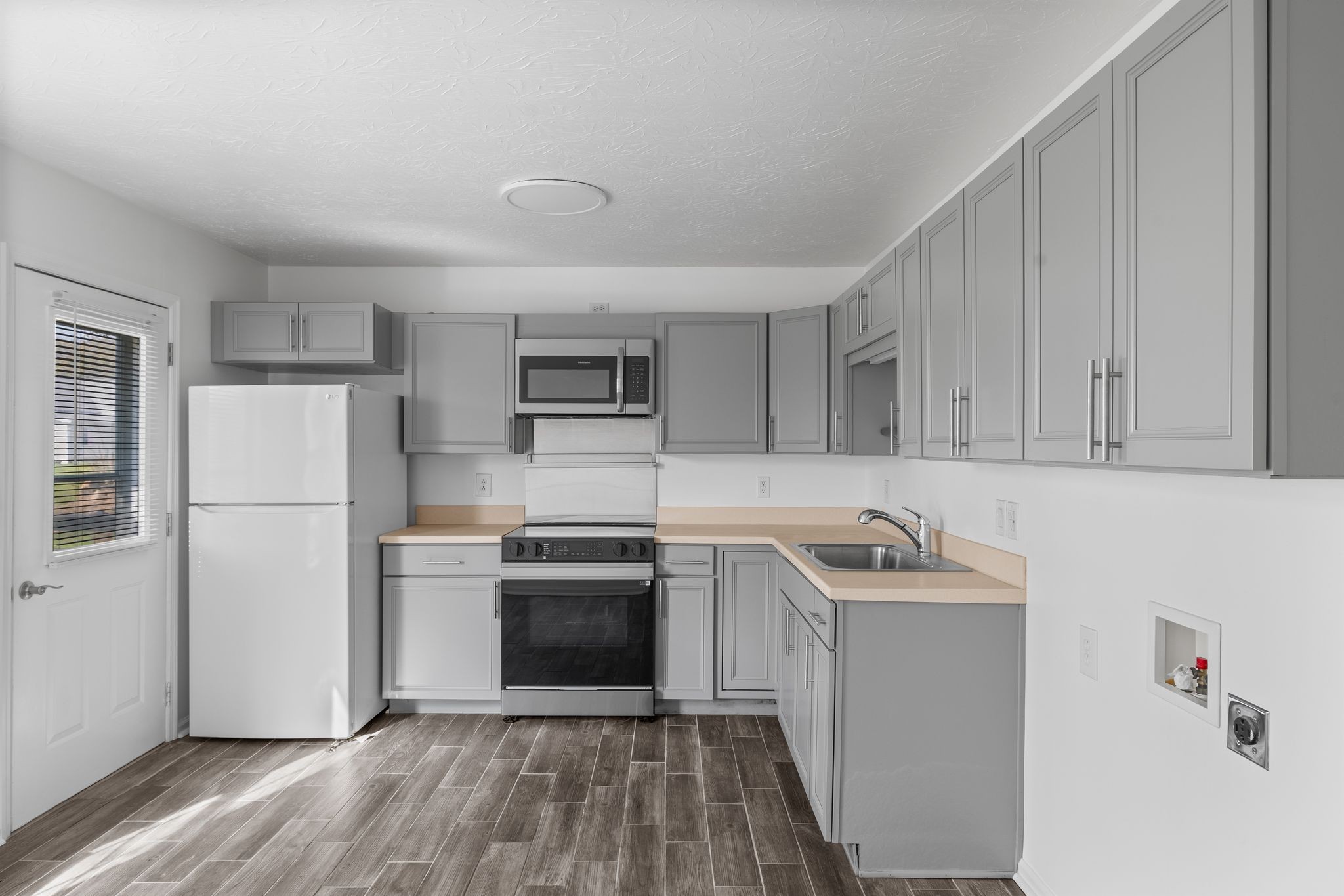 104 East Merchant Street Mount Pleasant, TN 38474 - Photo 14 of 30 a kitchen with a sink a refrigerator and cabinets