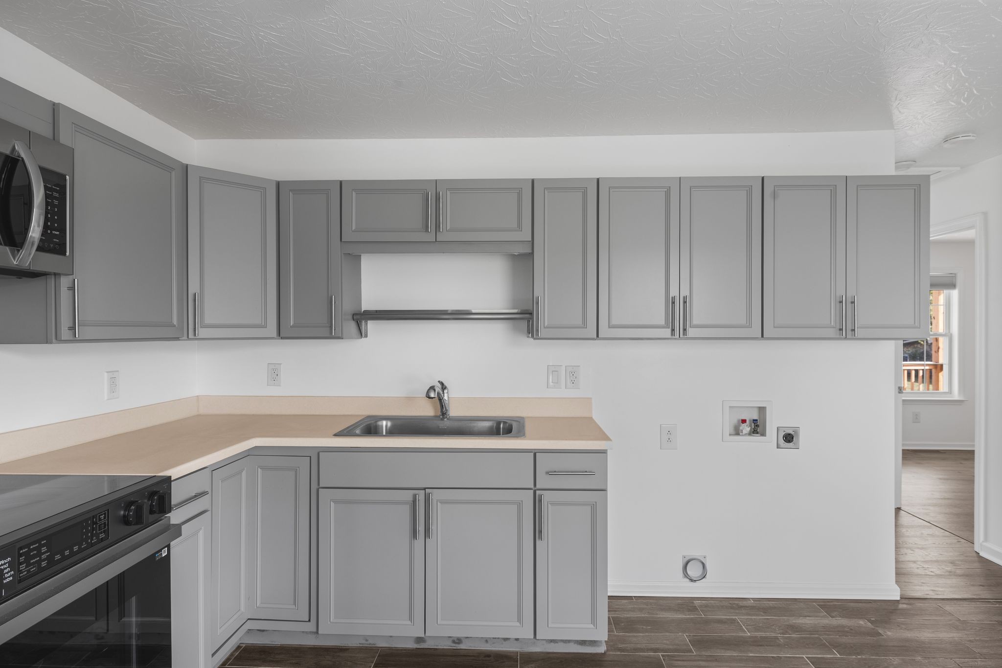 104 East Merchant Street Mount Pleasant, TN 38474 - Photo 15 of 30 a kitchen with a sink cabinets and stainless steel appliances