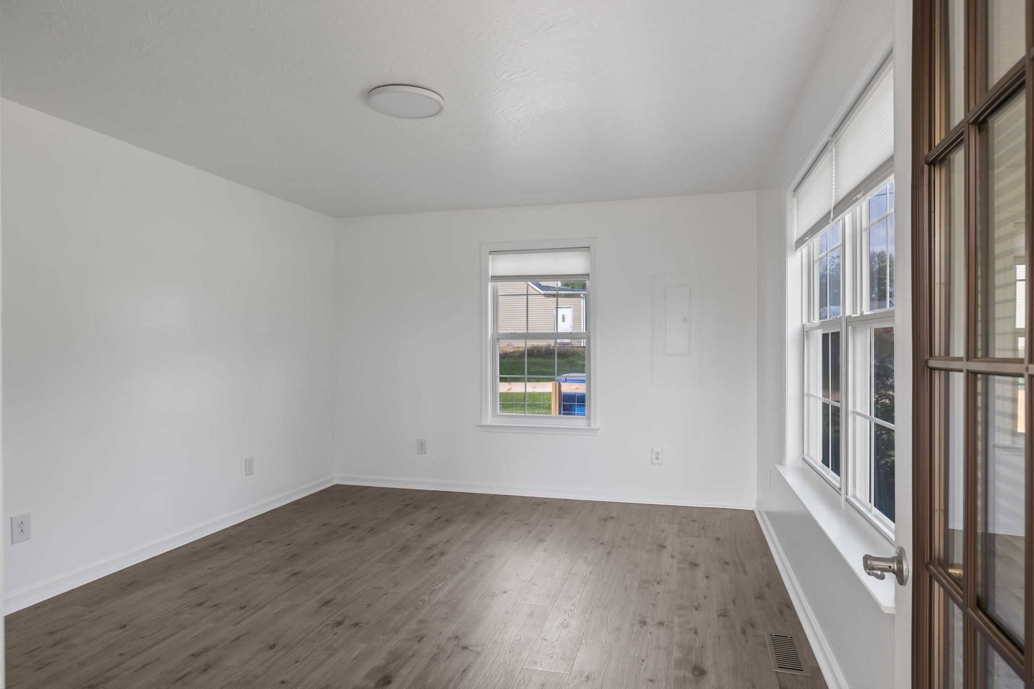 104 East Merchant Street Mount Pleasant, TN 38474 - Photo 8 of 30 an empty room with wooden floor and windows