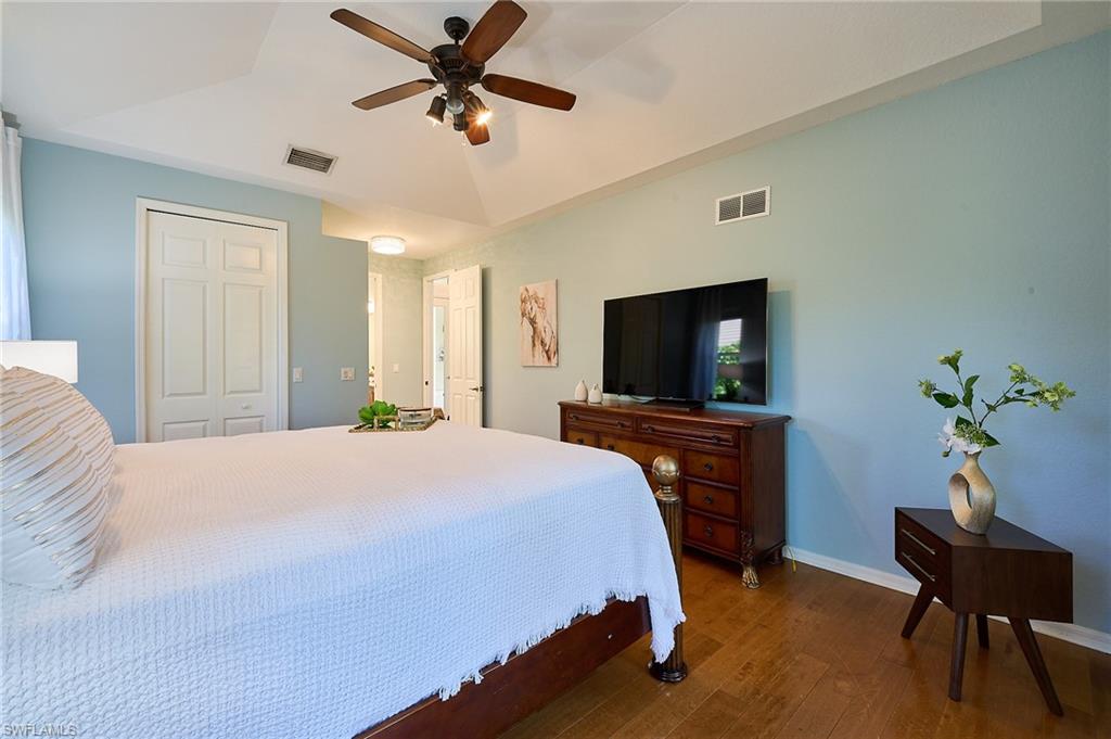186 Muirfield Circle Naples, FL 34113 - Photo 17 of 36 a bedroom with a bed and a flat screen tv