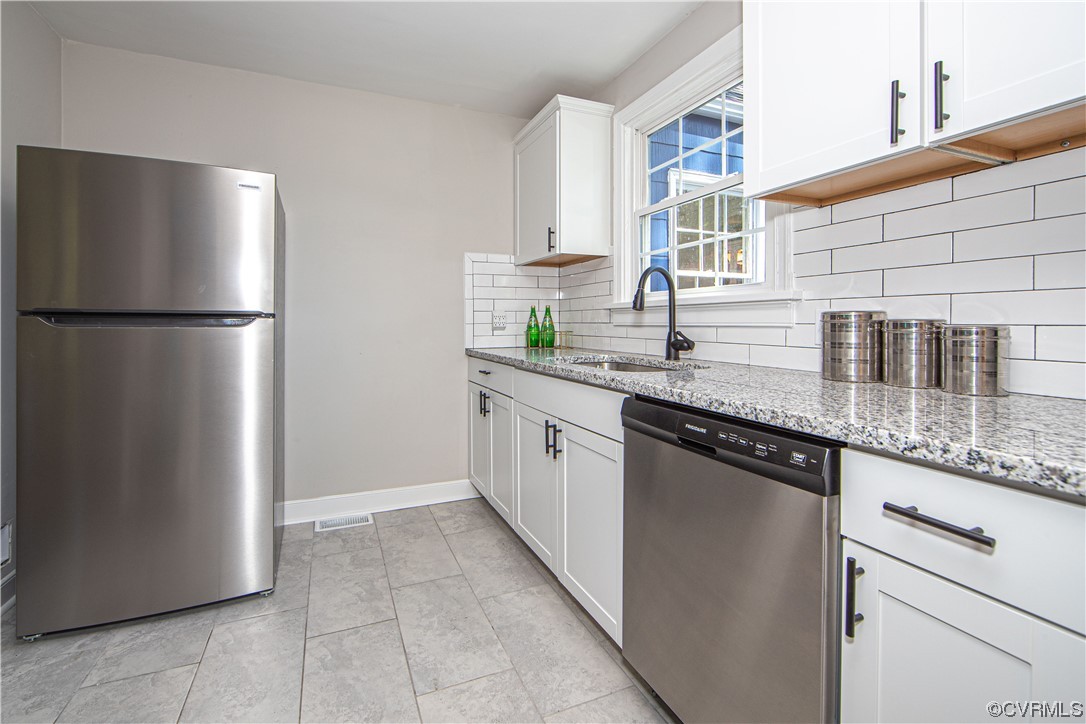 3009 Pinehurst Road Henrico, VA 23228 - Photo 15 of 34 Kitchen with stainless-steel appliances, white cabinetry, tile backsplash, stainless-steel sink with disposal, granite countertops, tile floor and access to the laundry room