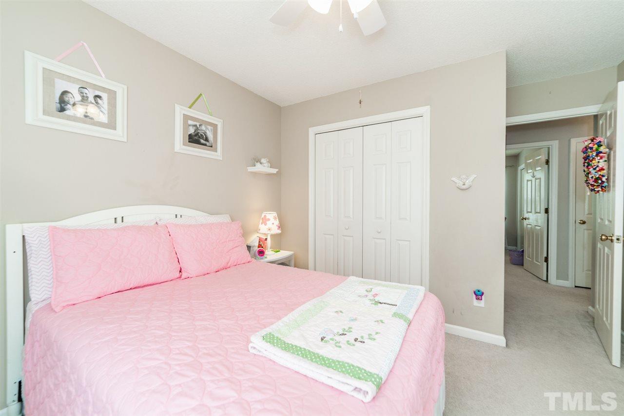 9300 Shallcross Way Raleigh, NC 27617 - Photo 17 of 25 a bedroom with a bed and a cabinets