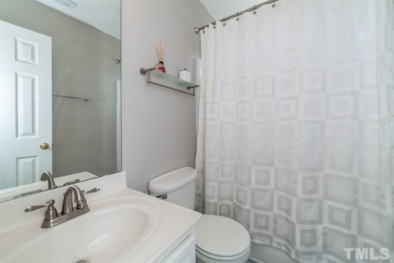 9300 Shallcross Way Raleigh, NC 27617 - Photo 18 of 25 a white toilet sitting next to a bathroom sink